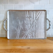 Load image into Gallery viewer, Vintage mid-century Hollywood Regency style forged aluminum serving tray which has the &quot;Bali Bamboo&quot; pattern embossed on the surface with two sturdy figural bamboo handles. Produced by the Everlast Metal Products Corporation, between 1946 - 1959. This striking mid-century serving tray would make a lovely addition to décor or for serving at a party.  In excellent vintage condition.  Measures 15 3/4 x 11 7/8 inches (not including handles)

