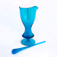 Load image into Gallery viewer, Stunning vintage mid-century laser blue hand blown glass martini cocktail pitcher with matching teardrop shaped glass stirring rod. The pitcher has a distinct feminine shape with a footed bottom and the colour is out of this world!  In excellent condition, free from chips/cracks.  Pitcher measures 5&quot; x 10-1/4&quot;, glass rod 10-1/4&quot;
