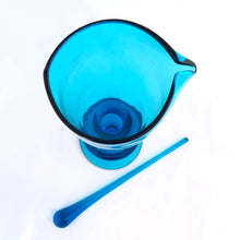 Load image into Gallery viewer, Stunning vintage mid-century laser blue hand blown glass martini cocktail pitcher with matching teardrop shaped glass stirring rod. The pitcher has a distinct feminine shape with a footed bottom and the colour is out of this world!  In excellent condition, free from chips/cracks.  Pitcher measures 5&quot; x 10-1/4&quot;, glass rod 10-1/4&quot;
