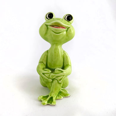 Adorable vintage mid-century ceramic figurine of a smiling and cross-legged seated lime green frog. Produced by Noritake of Japan for Gift Craft Toronto, circa 1970s. A great decor piece...it's just such a happy and fun piece!  In excellent  condition free from chips/cracks/repairs.  Measures 3 1/2 inches tall