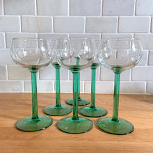Load image into Gallery viewer, A vintage mod set of 6 elegant Luminarc pale teal green stemmed wine glasses. These were made in the 1960s by J.G. Durand Cristal d&#39;Arques in France. We are loving the vibrancy of the stems that will add that perfect pop of colour to your tablescape. Cheers!  All are in excellent condition free from chips/cracks. Marked &quot;FRANCE&quot; on the bottom.  Each glass measures 2 3/4 x 6 1/2 inches  Capacity 5 ounces
