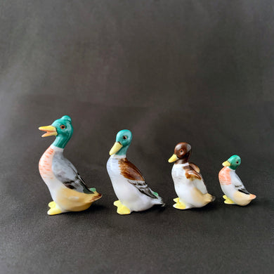Vintage set of four miniature hand painted porcelain figurines of a stand Mallard ducks. Produced by Metzler & Ortloff of Germany. These were created for export market between 1923 - 1972.  In excellent condition, no chips or cracks. Crazing present. Maker's mark on the bottom of each bird.  Approximate heights of each bird are: 1-3/4