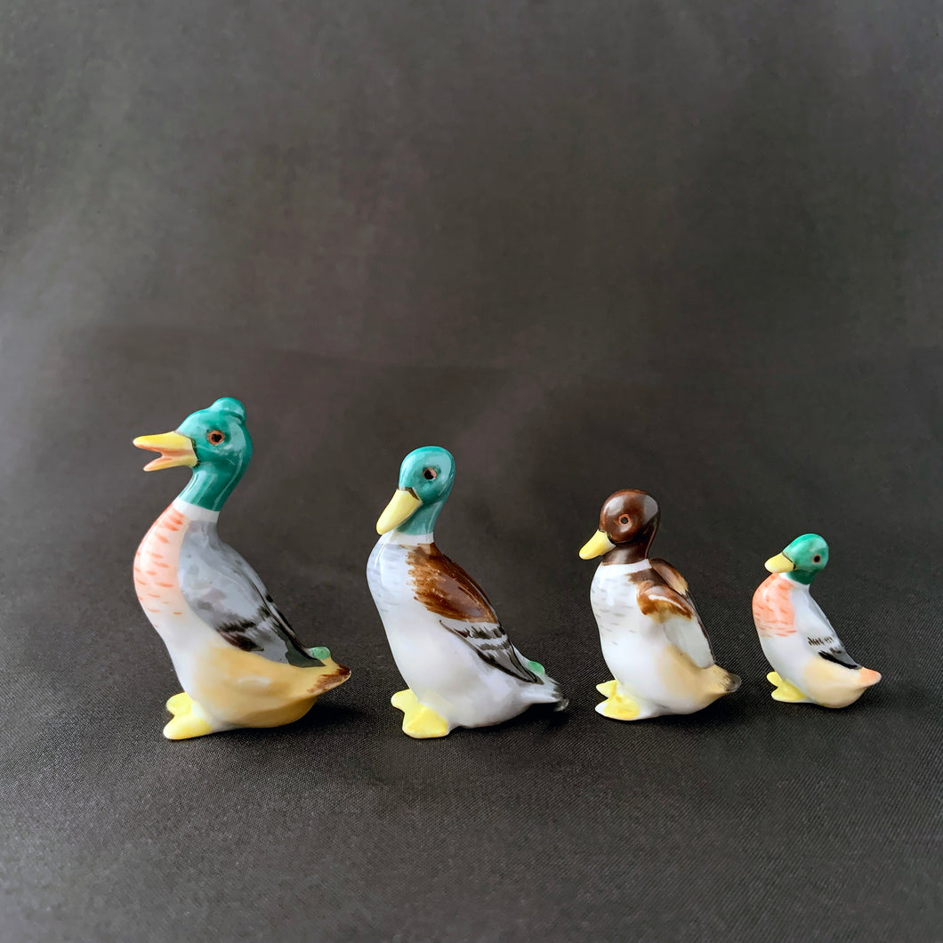 Vintage set of four miniature hand painted porcelain figurines of a stand Mallard ducks. Produced by Metzler & Ortloff of Germany. These were created for export market between 1923 - 1972.  In excellent condition, no chips or cracks. Crazing present. Maker's mark on the bottom of each bird.  Approximate heights of each bird are: 1-3/4