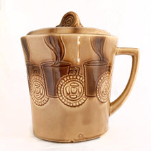Load image into Gallery viewer, Check out this cool ceramic coffee cup shaped cookie jar decorated with steaming cups of hot bevvies and cookies and the lid is super cute with a curled cloud of steam for a handle. Produced by McCoy Pottery in the USA, between 1963-1966. Marked &quot;USA&quot; on the handle.  In excellent condition, free from chips/cracks/repairs.  Measures 7-1/2&quot; x 9-1/4&quot;
