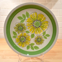 Load image into Gallery viewer, So nice to see a touch of Spring! We are loving this vibrant chop plate filled with yellow and green flowers in the &quot;Crispy&quot; pattern. Produced by Mikasa in Japan between 1974 - 1976. This large serving plate will liven up any tablescape, or use as wall decor to brighten your walls!  In excellent condition, no chips or cracks.  Measures 12 1/4 inches
