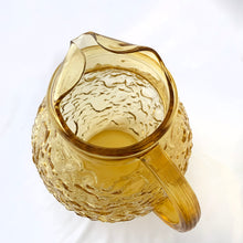 Load image into Gallery viewer, Vintage &quot;Miliano Honey Gold&quot; glass beverage pitcher with textured surface and ribbed handle. Made by the Anchor Hocking Glass Company, between 1960-1969.  In excellent condition, free from chips/cracks.  Measures 2-1/4&quot; x 3-7/8&quot; and holds 96 ounces
