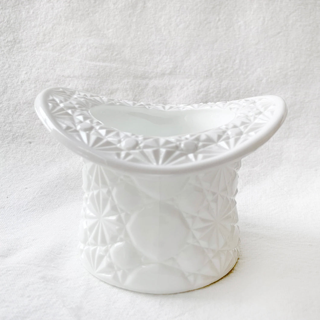 A vintage milk glass top hat dish in the 