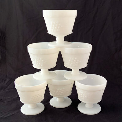 vintage mid-century milk glass champagne or tall sherbets. Anchor Hocking Glass for Big Top Peanut Butter promo for Proctor and Gamble. These dishes feature a cluster of grapes on a vine against a stippled background with a scalloped border at the rim. Perfect for serving shrimp cocktail, desserts or champagne. They may even be used as planters or to hold small office supplies. In excellent condition, free from chips/cracks. Measures 3 1/2 x 3 1/8 inches