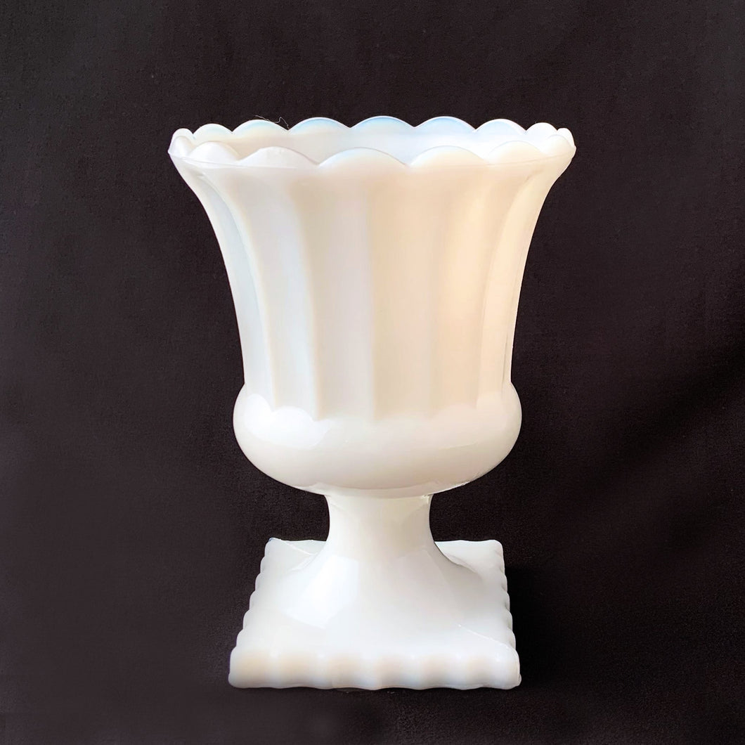 Grecian style milk glass planted. Its fluted shape is ultra feminine and would be perfect for a pretty floral display, or your favourite house plant. Or repurpose as a candy dish, pencil or make-up brush holder. Produced by Hazel-Atlas Glass, USA.   In excellent condition, no chips or cracks.  Measures 4 1/2 x 6 inches