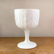 Load image into Gallery viewer, Classic goblet shaped milk glass planter with vertical leaf pattern. Perfect for a pretty floral display, or your favourite house plant. Or repurpose as a candy dish, pencil or make-up brush holder. Produced by FTD.  In excellent condition, no chips or cracks.  Size: 4-1/4&quot; x 6-3/8&quot;
