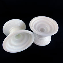 Load image into Gallery viewer, This is a really cool pair of vintage milk glass candle holder pedestal with raised swirl detail, circa 1960. What makes them cool and practical is that they accommodate taper candles, 2&quot; votives, 3&quot; pillar and 3.5&quot; pillar candles. Unmarked.  In excellent condition, no chips or cracks.  Measures 4 1/2 x 3 1/4 inches

