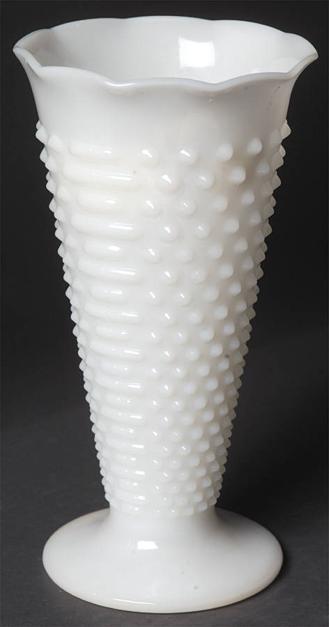 A white milk glass trumpet vase in the 