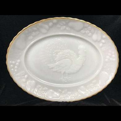 Classic vintage milk glass platter featuring a central embossed turkey surrounded by a border of fall fruits and finished with a gold gilt scalloped edge. Crafted by Anchor Hocking Glass, USA, circa 1960s. Make the turkey to star of any occasion with this lovely platter!  In excellent condition, no chips or cracks, some wear to the gold. Marked on the bottom.  Measures 15 1/2 x 11 3/4 inches   