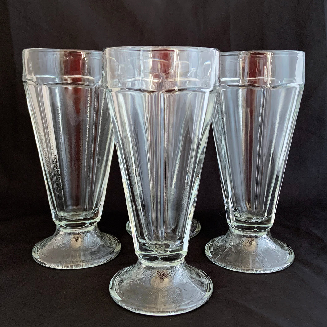 These classic vintage mid-century modern fountainware soda glasses are the real deal, featuring a six panel design, with stippled foot. Crafted by Libbey Glass Canada, circa 1950/60s. Perfect for making tasty floats, milkshakes or sundaes.  In excellent condition, no chips or cracks. Marked 
