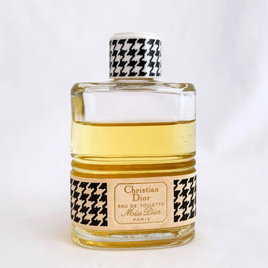 Vintage partial 2 ounce bottle of 'Miss Dior' eau de toilette. Created by perfumer François Demachy for Christian Dior, Paris France. As Dior's debut fragrance, Miss Dior was introduced in 1947 alongside the first Christian Dior collection in Paris at 30 Avenue Montaigne.  While this is in used condition, the glass bottle and label are in excellent condition.  Approximately 1 1/2 ounces remain in the bottle.