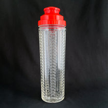 Load image into Gallery viewer, Vintage Art Deco style  NYC Skyscraper pressed glass cocktail shaker with red plastic dial-a-recipe lid with strainer. A fantastic conversation piece to add to your bar cart. Designed by Harry C. Gessler and produced by Medco Products Company in the USA, between 1935 - 1952. 
