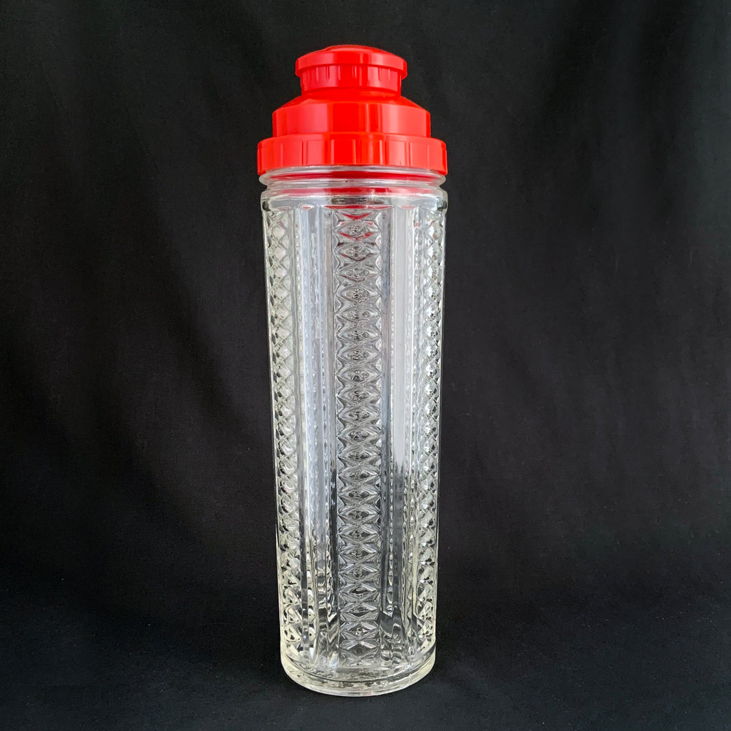 Vintage Art Deco style  NYC Skyscraper pressed glass cocktail shaker with red plastic dial-a-recipe lid with strainer. A fantastic conversation piece to add to your bar cart. Designed by Harry C. Gessler and produced by Medco Products Company in the USA, between 1935 - 1952. 
