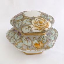 Load image into Gallery viewer, This six sided lidded trinket box is eye catching! It is beautifully hand painted with roses in shades of pink, purple, yellow and green with gold moriage details. An elegant addition to your decor!  In excellent condition, no chips, cracks or repairs. Marked on the bottom with the maple leaf, Nippon, Hand Painted.  Measures 4-1/2 x 3-3/4 inches JacksDaughterVintage Etsy
