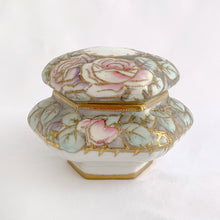 Load image into Gallery viewer, This six sided lidded trinket box is eye catching! It is beautifully hand painted with roses in shades of pink, purple, yellow and green with gold moriage details. An elegant addition to your decor!  In excellent condition, no chips, cracks or repairs. Marked on the bottom with the maple leaf, Nippon, Hand Painted.  Measures 4-1/2 x 3-3/4 inches JacksDaughterVintage Etsy
