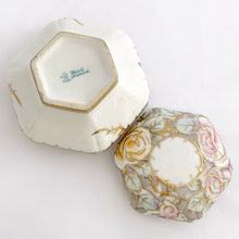 Load image into Gallery viewer, This six sided lidded trinket box is eye catching! It is beautifully hand painted with roses in shades of pink, purple, yellow and green with gold moriage details. An elegant addition to your decor!  In excellent condition, no chips, cracks or repairs. Marked on the bottom with the maple leaf, Nippon, Hand Painted.  Measures 4-1/2 x 3-3/4 inches JacksDaughterVintage Etsy
