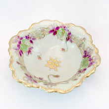 Load image into Gallery viewer, This stunning porcelain Nippon bowl is hand painted in a romantic style with beautifully rendered violets, green leaves lined with gold details resembling a musical staff, with moriage along the rim.  In excellent condition, no chips or cracks.  Measures 5 1/2 x 2 1/2 inches
