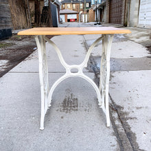 Load image into Gallery viewer, Upcycled vintage cast iron Singer sewing treadle table, painted creamy white with pine wood top. Perfect as an hall/end table, microwave or plant stand!
