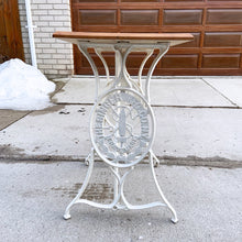 Load image into Gallery viewer, Upcycled vintage cast iron Singer sewing treadle table, painted creamy white with pine wood top. Perfect as an hall/end table, microwave or plant stand!
