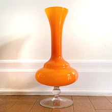 Load image into Gallery viewer, This vintage mid-century Empoli art glass vase features a captivating white interior encased in an orange exterior complete with a clear pedestal - an ideal accent piece for adding vibrancy to your home décor.  In excellent condition, free from chips/cracks.  Measures 7 1/2 x 16 inches
