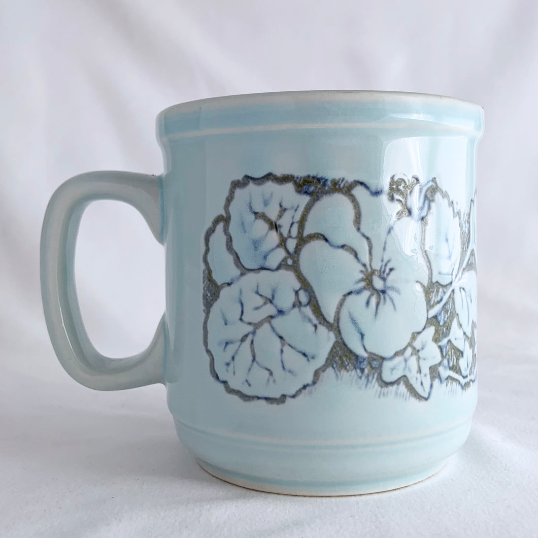 Lovely vintage stoneware mug beautifully embossed with flowers over a pale blue glaze. Produced by WP, England, circa 1970s.  In excellent condition, free from chips/cracks.  Measures 3 1/4 x 3 3/8 inches