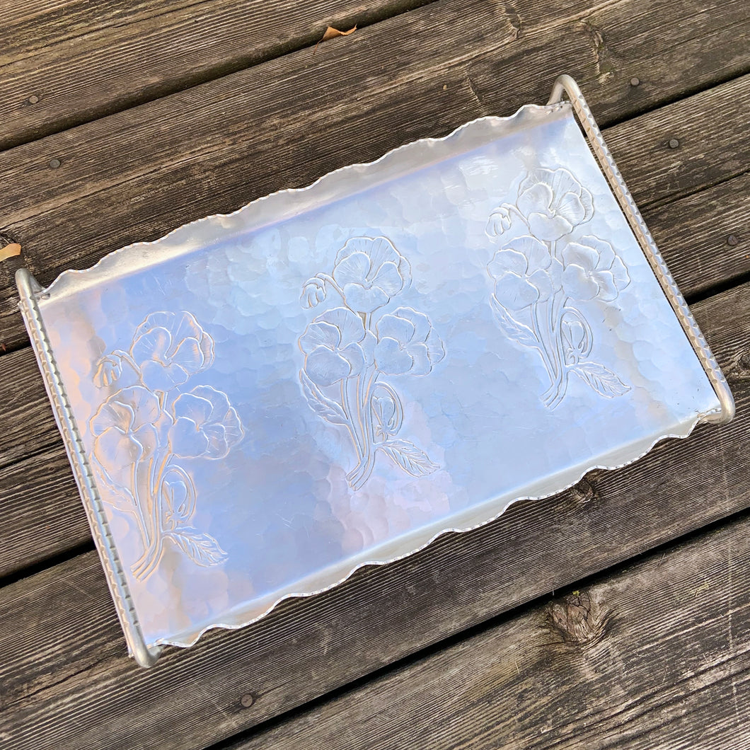 Vintage mid-century hand wrought hammered aluminum  tray in 'Pansy' pattern, shape 273 with raise detailed handles. Made by Hammercraft Canada, circa 1950. A great serving tray for cocktails or nibbles and a perfect addition to your bar cart.  In great vintage condition.  Size: 176