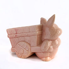 Load image into Gallery viewer, Adorable vintage pink ceramic planter of a bunny rabbit pulling a wagon. Made in Taiwan, circa 1960. Fill this pretty planter with your favourite houseplant or succulents. Could be filled with some delicious confections for a lovely Easter gift or display!  In excellent condition, free from chips/cracks/repairs.  6 1/2 x 3 1/2 x 5 inches
