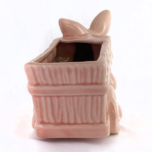 Load image into Gallery viewer, Adorable vintage pink ceramic planter of a bunny rabbit pulling a wagon. Made in Taiwan, circa 1960. Fill this pretty planter with your favourite houseplant or succulents. Could be filled with some delicious confections for a lovely Easter gift or display!  In excellent condition, free from chips/cracks/repairs.  6 1/2 x 3 1/2 x 5 inches
