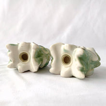 Load image into Gallery viewer, Pretty figural poinsettia set of salt and pepper shakers. These are painted in white with pale green and silver accents. Perfect for anytime of year!  In excellent condition, no chips or cracks. Nicely weighted and appear to be in new old stock.

