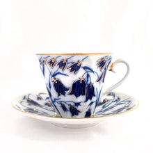 Load image into Gallery viewer, Elegant porcelain tea cup and saucer, hand painted with blue bell flowers with gold details (design 1744). Produced by Russian Imperial Lomonosov in St. Petersbourg, Russia.  In excellent condition, free from chips/cracks/wear. Makers marks on the bottom of each piece.  Tea cup measures 3-1/2&quot; x 2-7/8&quot; and the saucer measures 5-3/4&quot;
