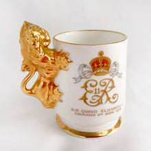 Load image into Gallery viewer, Vintage Staffordshire bone china white miniature souvenir mug made for the coronation of Queen Elizabeth II with the royal crest on one side, date of crowning on the other and a stylized lion handle with gold gilt finish. Produced by Arthur Bowker, England.  In excellent condition, free from chips/cracks/repairs. Marked on the base &quot;STAFFORDSHIRE FINE BONE CHINA OF ARTHUR BOWKER MADE IN ENGLAND&quot;  Measures 2-3/4&quot; x 1-7/8&quot; x 2-3/4&quot;
