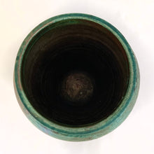 Load image into Gallery viewer, Striking pottery vase in tones of green and copper and fired using the Raku process. Raku is a Japanese method of pottery making dating back to the 1500s. The clay object is removed from the kiln at the height of firing which causes it to cool very quickly causes unusual results and it&#39;s signature black clay. This piece is signed on the bottom &quot;Pat Patterson Waterdown&quot;.  In excellent condition, free from chips/cracks.  Measures 5 1/2 x 8 1/2 inches
