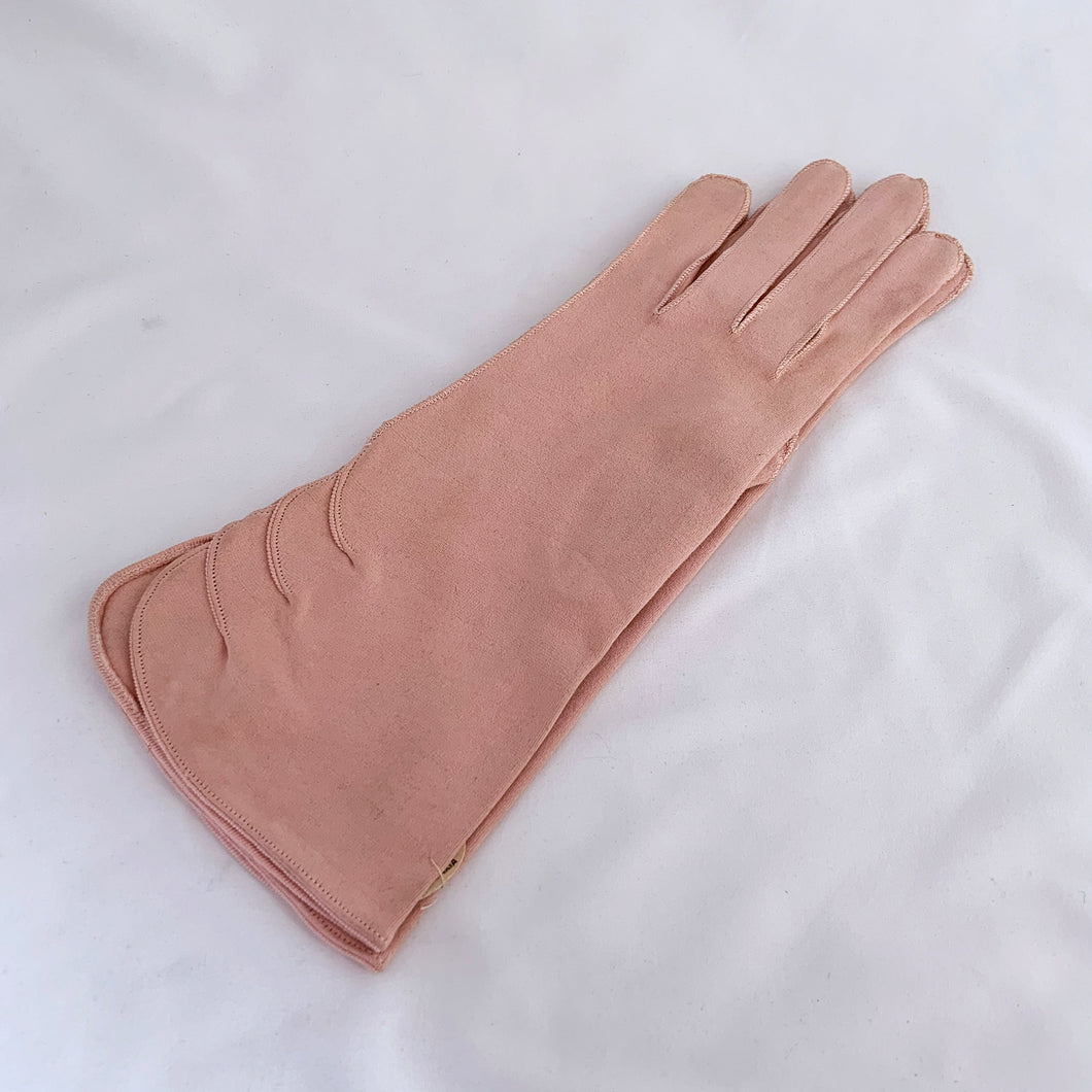 TV and movie prop stylists. Never worn, vintage mid-century rose pink cotton gloves with scalloped detail above the split cuff. Impeccable workmanship. Produced in Czechoslovakia, circa 1950s. Perfect for everyday, a special occasion, or costume styling. In new condition. Original makers tag and Eatons price tag Toronto department store no longer in business. Label states size 6 1/2.  Measures 3 inches at the widest part of the hand, 4 1/2 inches at the cuff and 10 5/8 inches in length.