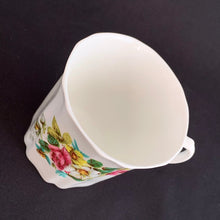 Load image into Gallery viewer, Treat yourself to a cuppa in this lovely feminine shaped fine bone china mug featuring beautiful bouquet of white, yellow and pink roses with green leaves on white bone china. Crafted by Royal Grafton, England, circa 1970s. Grafton made these mugs with many floral designs — collect them all!  In excellent condition, no chips, cracks or crazing. Marked on the bottom with &quot;Royal Grafton, Fine Bone China, Made in England&quot;.  Measures 3 1/4 x 3 1/4 inches
