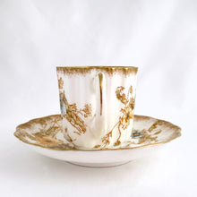 Load image into Gallery viewer, Antique Rutland demitasse cup and saucer, with blue and yellow flowers trimmed in gold gilt. Produced by Doulton Burslem, England, circa 1900. In excellent condition, free from chips, cracks, repairs. Cup stamped green DOULTON BURSLEM ENGLAND, red hand painted mark 66254 with three lines crossed out below. Saucer stamped with brown DOULTON BURSLEM ENGLAND and RUTLAND Rd 168550 U.S.PATENT, red hand painted mark 66154 with a 9 below. Cup 2-1/8&quot; x 2-1/8&quot; and saucer approximately 4&quot;
