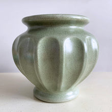 Load image into Gallery viewer, The sage green colour with tiny brown flecks is perfection on this round Grecian style urn round planter. Produced by Haeger U.S.A. for FTD, circa 1970. Fill this beauty with houseplants, succulents or a beautiful bouquet of flowers. Whatever you choose it&#39;ll make a fabulous addition to your décor. In excellent condition, no chips or cracks. Stamped on the bottom with DESIGNED EXCLUSIVELY FOR FLORISTS TELEGRAPH DELIVERY ASSOCIATION, HAEGER USA. Measures 6 1/4 x 6 1/2 inches
