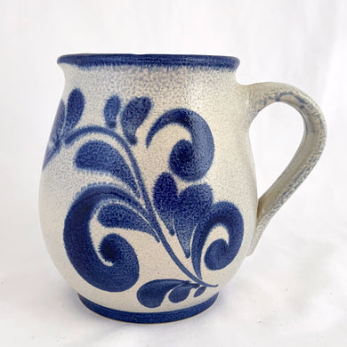 Pretty and practical limited edition salt-glazed pottery creamer or milk pitcher with a floral design in cobalt blue. Marked 73/92 on the bottom.  In excellent condition, no chips or cracks.  Measures 4