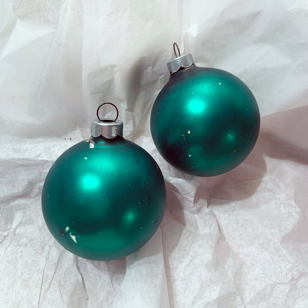 A pair of classic hand blown vintage glass Christmas tree ornaments in satin green with great patina.  In vintage condition.  Each measures 2