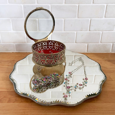 Beautiful vintage Victorian scalloped and beaded edge mirror or vanity stand. This metal backed mirror may be used on a flat surface or hung on a wall. It's a lovely piece that would add some romance to any space.   In good used vintage condition, minor marks to the mirror surface.   Measures 12 x 1/2 inches