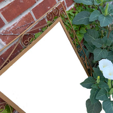 Load image into Gallery viewer, A vintage mirror featuring a fabulous wrought iron scroll design, painted gold and backed in wood. All ready to hang!  In great vintage condition
