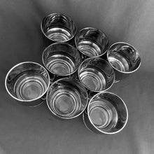 Load image into Gallery viewer, Mid-century vintage silver sided whisky cocktail glasses are perfect for any occasion. Set of four. Decorated with a silver sides and clear base. These will certainly add some vintage glamour to your bar cart!   In excellent condition, no chips or cracks.  Size: 2-3/4&quot; x 2-3/4&quot;
