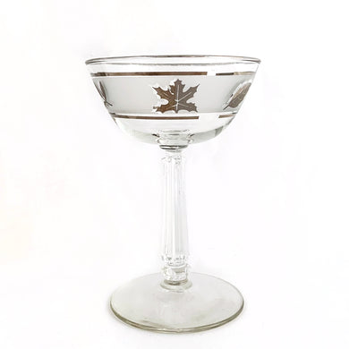 Vintage mid-century Silver Leaf champagne coupe or martini glass featuring silver leaves set on a frosted band, silver bands, grecian column stem. Crafted by Libbey Glass, USA, 1953 - 1978. These put the 