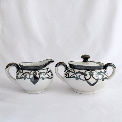 Vintage white porcelain with silver overlay creamer and covered sugar bowl in the art nouveau style. Produced by Limoges Bernardaud (B&Co) France, circa 1940.  In excellent condition, free from chips/cracks/repairs.  Sugar measures 4