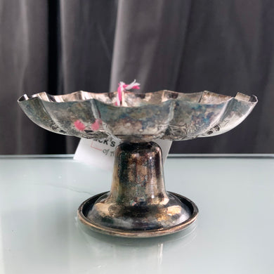 Vintage silver plated scalloped edge pedestal dish with lovely pierced detail giving the dish a doily-like effect along with an engraved pattern. Has a little light wear and tarnish, we left it just as we found it and could easily be polished if a brilliant finish is desired. The perfect piece to brighten up a vanity table to hold trinkets, in a powder room to display fancy soaps or in an entryway filled with treats.  In good vintage condition. Marked EPNS, 