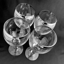 Load image into Gallery viewer, Mid-century vintage silver rimmed wine glasses with a silver are perfect for any occasion!  Decorated with a silver rim and band below. These will certainly add some vintage glamour to your bar cart!   In excellent condition, no chips or cracks.  Size: 3&quot; x 7&quot;
