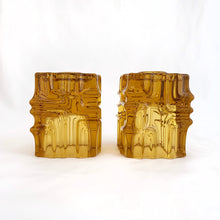 Load image into Gallery viewer, Stunning pair of vintage mid-century bohemian amber candle holders made of mold-blown glass with a brutalist design. These can be used for tapers on one side and votive candles on the other side. Designed by glass and jewellery artist Vladislav Urban for Sklo Union during his tenure at Rosice Glassworks, Czechoslovakia, circa 1968.   In excellent condition, free from chips/cracks.  Measures 2 3/8 x 2 3/8 x 3 1/8 inches

